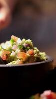 Close-up of fresh guacamole being served with tortilla chips in a dimly lit Bangkok restaurant video