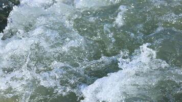 Close-up of turbulent water in Lake Wakatipu, showcasing natural motion and dynamic textures under bright lighting video