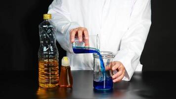 A scientist conducts a colorful liquid experiment, showcasing chemical reactions in a controlled lab environment video