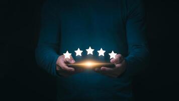 A concept of surveying and evaluating customer service satisfaction towards business, man is showing 5 star rating, indicating high satisfaction with service, online marketing, after-sales service. photo