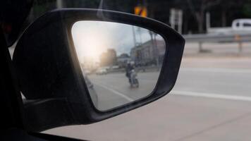 Inside view of mirrors wing. Driving on the concrete road. inside mirror wing with blurred of motorcycle. Clear traffic conditions during the day. photo