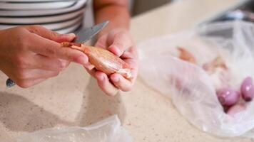 Hands peel shallots on a countertop, with natural lighting and a casual kitchen atmosphere video