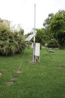 Weather Monitoring Station Set Up in a Beautiful Green Field for Data Collection and Analysis photo