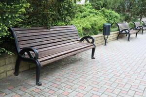 A Charming Wooden Park Bench Nestled in a Peaceful and Serene Outdoor Setting Surrounded by Nature photo