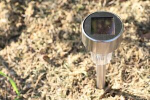SolarPowered Garden Light Placed Securely on Grass for Outdoor Aesthetics and Illumination photo