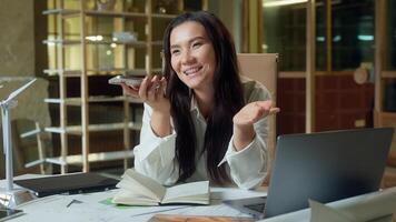 Asian businesswoman record audio message mobile phone send voice mail in office business woman friendly talking mic smartphone smiling Korean Japanese Chinese girl designer architect talk speakerphone photo