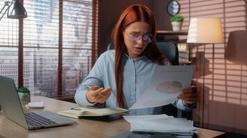 Stressed Caucasian woman businesswoman girl female business manager employer working laptop at office analyze diagram document mistake problem searching contract trouble problem papers burnout tired photo