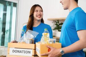 Donation and Community Support. Volunteers packing food items for donation in a cheerful environment. photo