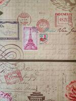 Vintage Postal Theme Eiffel Tower, Stamps, and Ephemera on Textured Surface photo