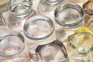 Clear glass jars arranged on a surface for display photo