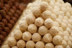 Delicious white sweets arranged in a pyramid formation photo