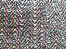Colorful beads form an abstract, textured pattern, creating a vibrant textile design for a unique backdrop photo