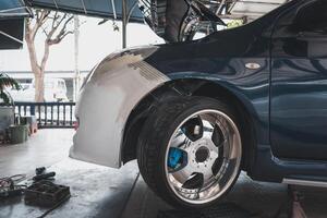 A car is being worked on by a mechanic photo