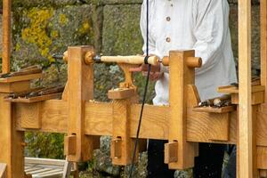 an artisan carpenter working in the traditional style at a historical reenactment party in Galicia photo