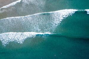 Atlantic Ocean Surf Session Seen from a Drone, Aerial drone top down View of Turquoise Ocean Waves Crashing photo