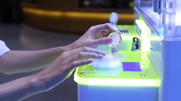 Hands interacting with a glowing game cabinet video