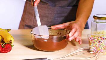 Mixing chocolate with fruits and sprinkles video