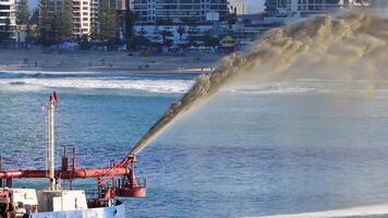 Aerial view of a dredging vessel pumping sand into the ocean, highlighting coastal management efforts on the Gold Coast video