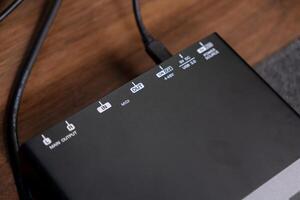 Black professional audio interface device showcasing Main Output, MIDI InOut ports, USB 3.0, and 48V power labels, essential for modern home studio music production setups photo