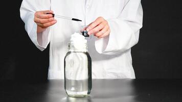 A scientist demonstrates a chemical reaction using dye and shaving cream in a laboratory setting video