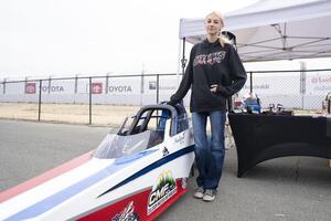 16 year old junior dragster driver Madi Jordan poses next to her race vehicle at Sonoma Raceway. editorial_image