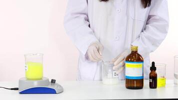 Scientist stirring chemicals demonstrating iodine clock reaction experiment video