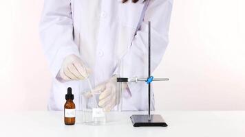 Scientist conducts experiment with silver nitrate solution video
