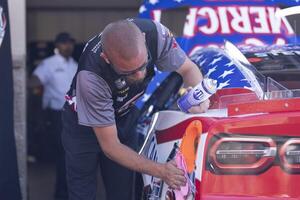 Crew member for NASCAR Cup Series driver Ricky Stenhouse Jr. (not pictured) wipes the vehicle before the race at Sonoma Raceway. editorial_image
