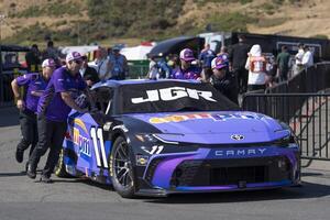 Crew members for NASCAR Cup Series driver Denny Hamlin (not pictured) pushes the vehicle onto pit row at Sonoma Raceway. editorial_image