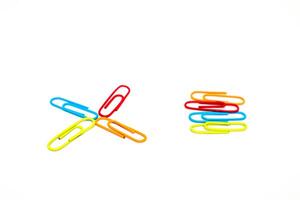 Colorful paper clips on a white background, arranged in a creative, organized and isolated view photo