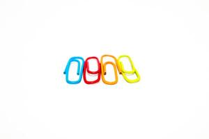 Colorful paper clips isolated on a white background, symbolizing organization and office work photo