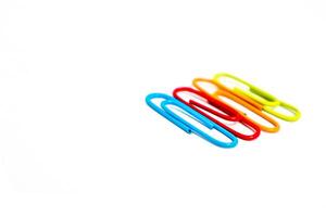 Colorful paper clips arranged on a white background, perfect for office or school related designs and presentations photo