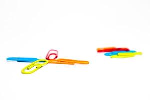 Colorful Paper Clips on a White Background with Minimalist Composition and Studio Lighting photo