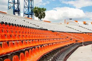 a section of a stadium with plastic seats. Ideal for use in articles about sports venues, event planning, or urban infrastructure photo