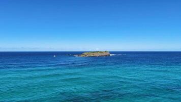Calm ocean waves near volcanic rock formation video