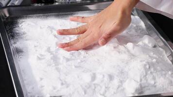 Hands interacting with baking soda on tray video