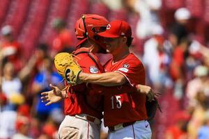 Cincinnati Reds relief pitcher Emilio Pagan (15) hugs catcher Tyler Stephenson (37) after the victory over the Colorado Rockies at Great American Ball Park. editorial_image