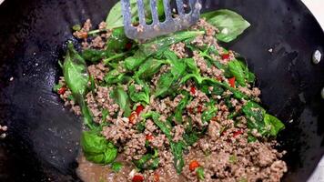Stir-frying beef and basil in a wok video
