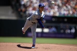 Los Angeles Dodgers starting pitcher Yoshinobu Yamamoto (18) delivers a pitch against the San Francisco Giants during the first inning at Oracle Park. editorial_image