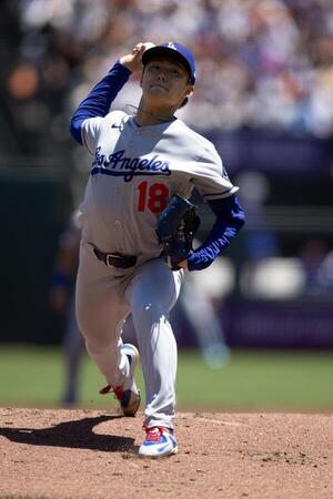 Los Angeles Dodgers starting pitcher Yoshinobu Yamamoto (18) delivers a pitch against the San Francisco Giants during the first inning at Oracle Park. editorial_image