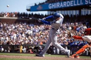 Los Angeles Dodgers first baseman Freddie Freeman (5) connects for an RBI single against the San Francisco Giants during the 11th inning at Oracle Park. editorial_image