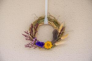 Handmade wreath decoration showcasing dried flowers, herbs, and natural elements perfect for enhancing home aesthetics throughout seasonal festivities and special occasions photo