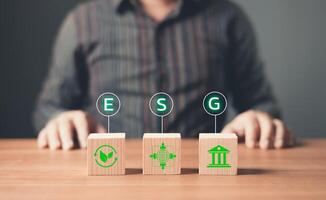 ESG environment social governance,Green Business Innovation and Sustainable Development concept.wood block with icon reduce co2,and reduce global warming,climate change,ecology friendly investment. photo