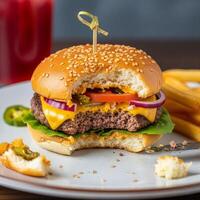 A cheeseburger with cheese, lettuce, tomato and onion on a plate photo