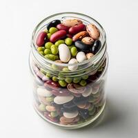 A jar filled with beans and peas on a white background photo