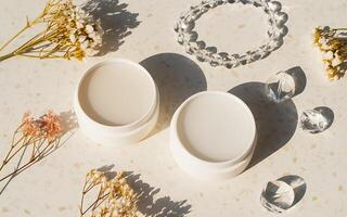 Two white containers with flowers and crystals photo