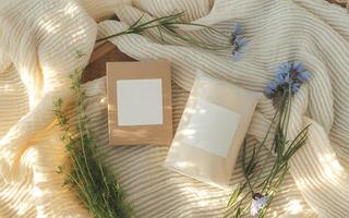Two boxes of soap on a blanket with flowers photo