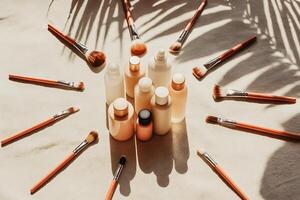 A group of makeup products arranged around a palm tree photo