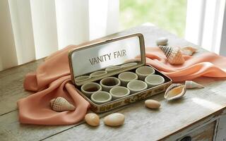 A table with a box of cups and a towel photo