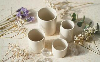 A group of white ceramic vases with flowers photo
